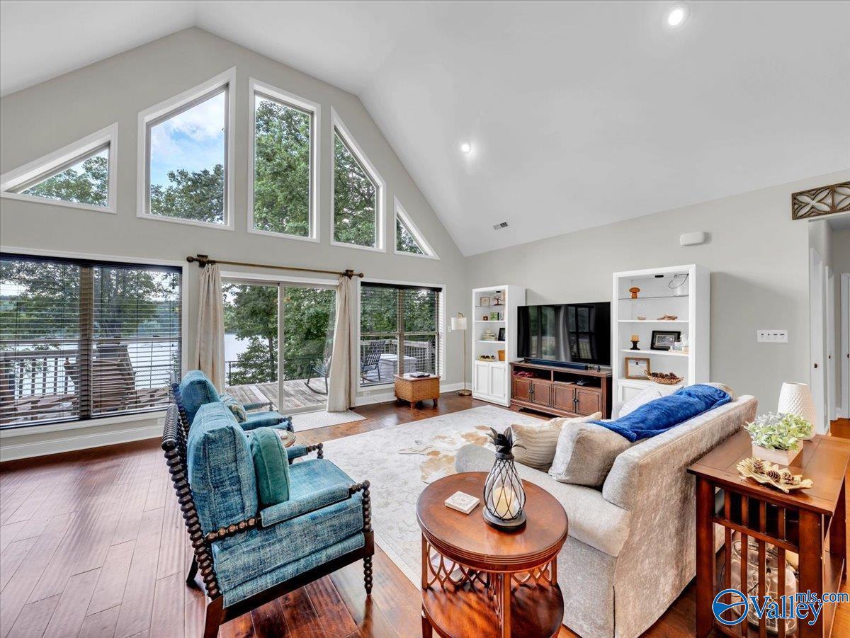 Image 2: Enjoy panoramic views and year-round sunshine from this spacious living room, highlighted by soaring ceilings and walls of glass that seamlessly connect indoor and outdoor living.
