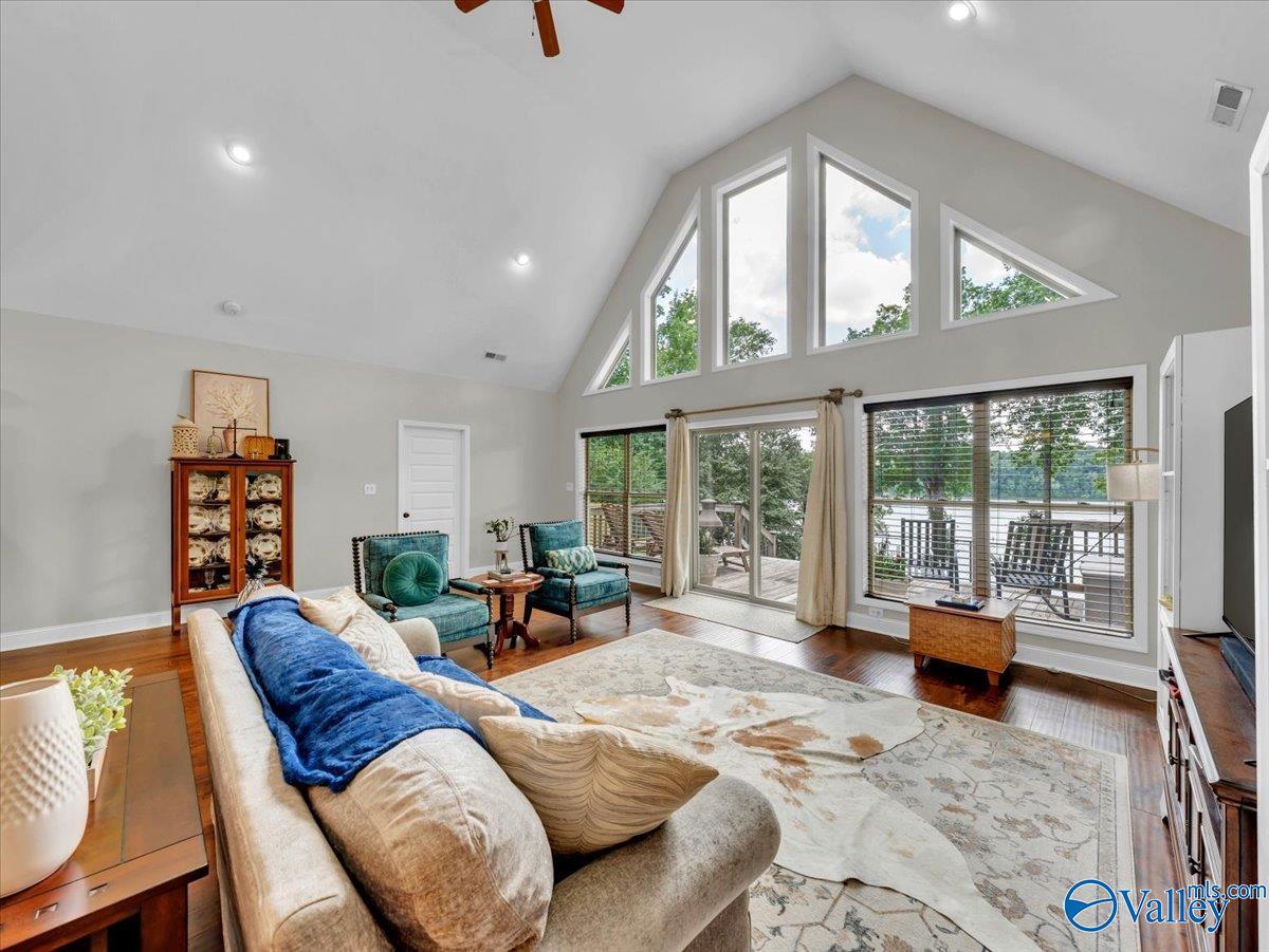 Image 4: Relax and unwind in this bright, open living room overlooking the scenic Elk River, complete with vaulted ceilings and expansive windows.