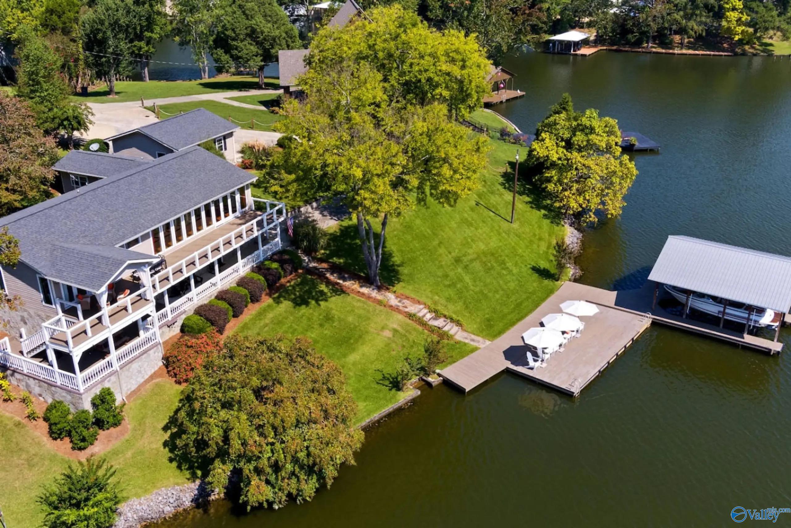 Image 2: Experience the ultimate lakefront lifestyle with this extraordinary waterfront residence offering 220 feet of prime Weiss Lake shoreline, expansive big-water views, and the rare blend of privacy, convenience, and effortless water access.
