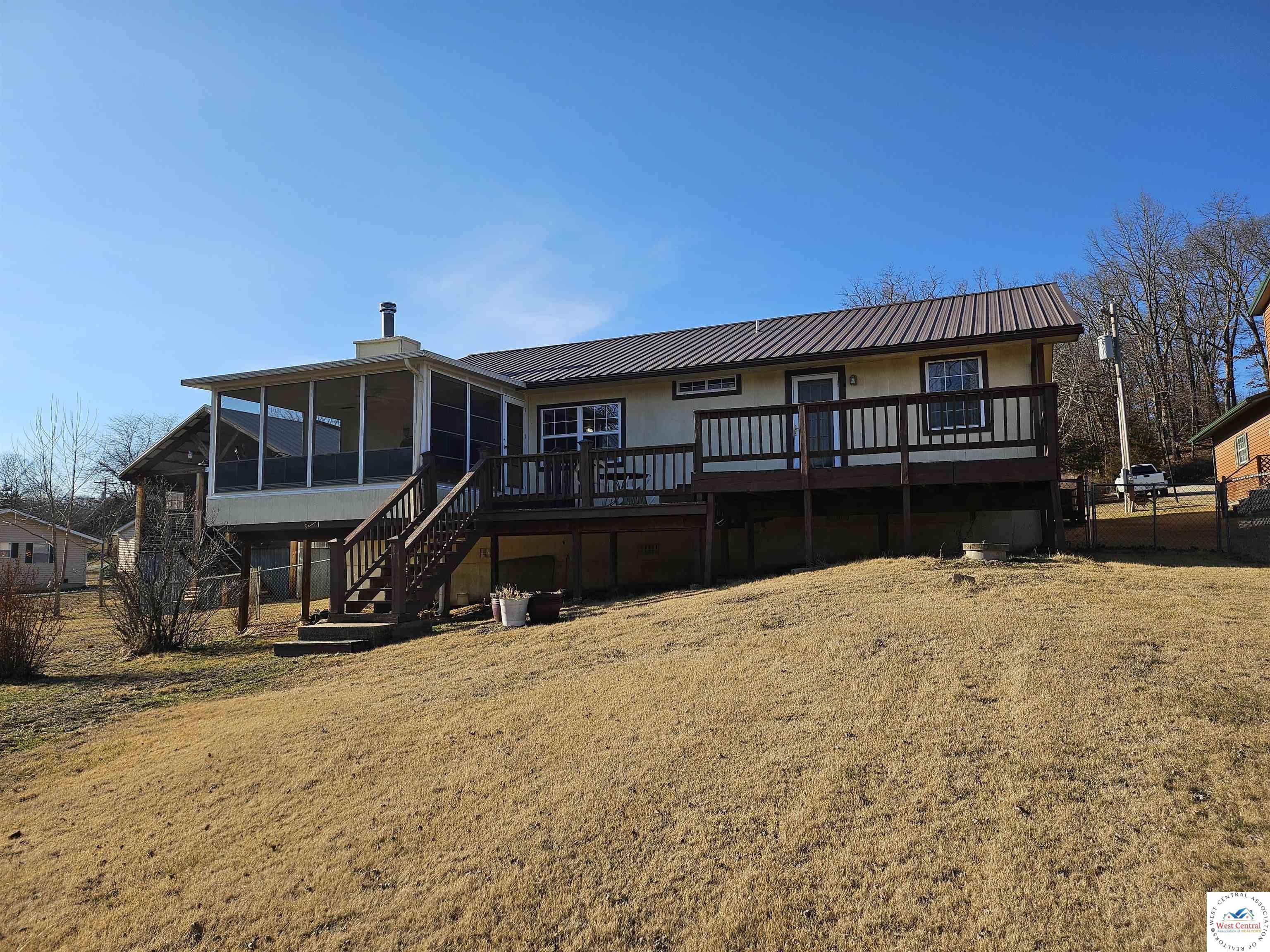 Image 2: This home has plenty of yard on the lakeside and the roadside. Land is gentle to level.