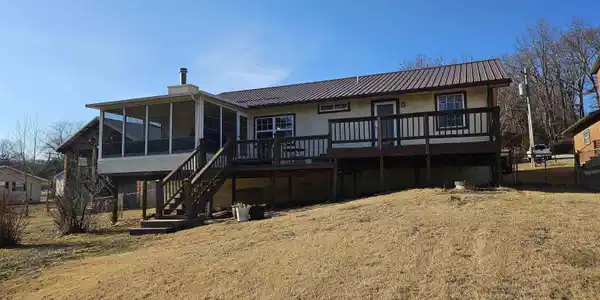 Image 2: This home has plenty of yard on the lakeside and the roadside. Land is gentle to level.