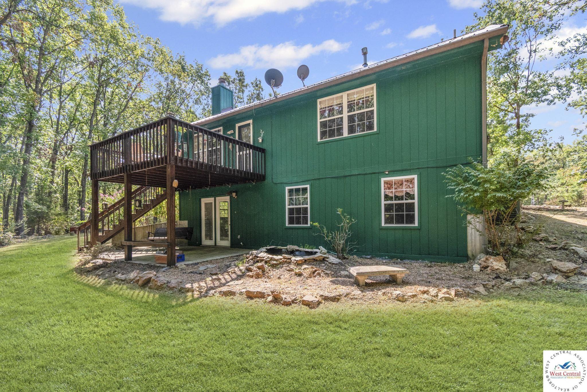 Image 4: Rear view of property with a patio, a deck, and yard