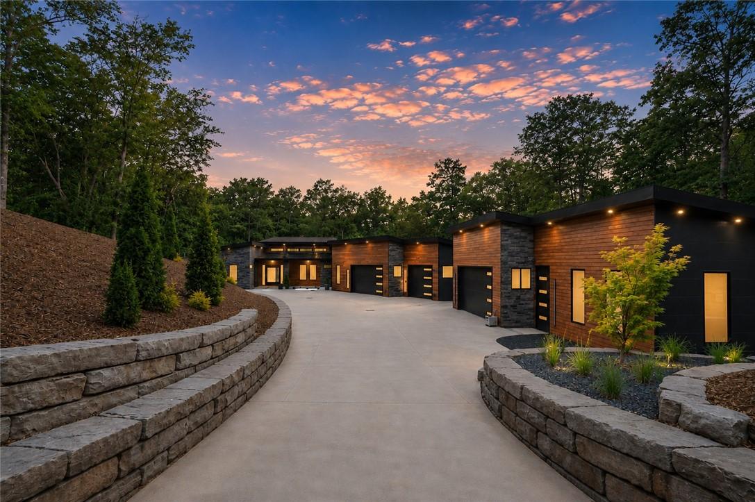 Image 3: A winding driveway leads to a modern home, beautif