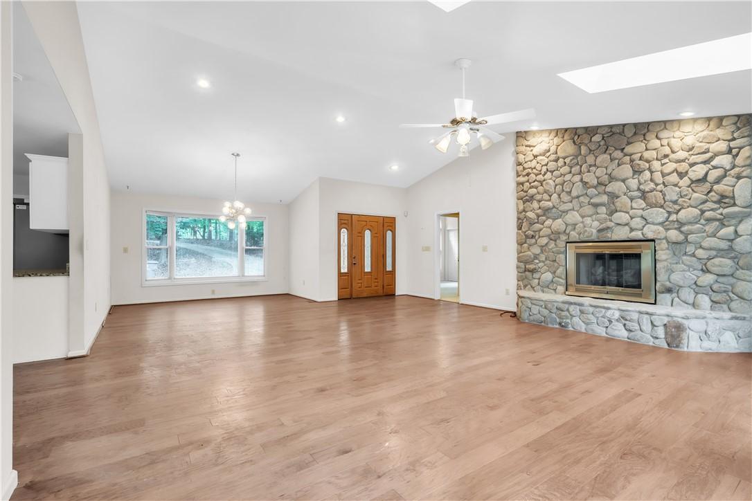 Image 4: Vast living area boasts vaulted ceilings, a river