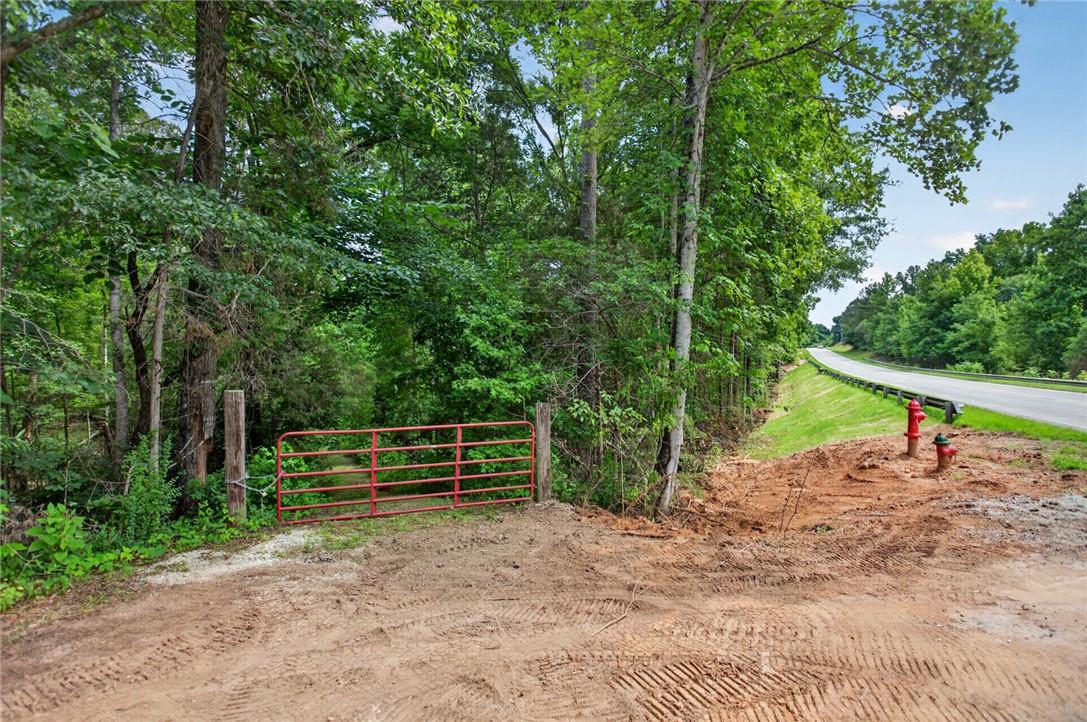 Image 4: A secluded, treed lot awaits development with conv