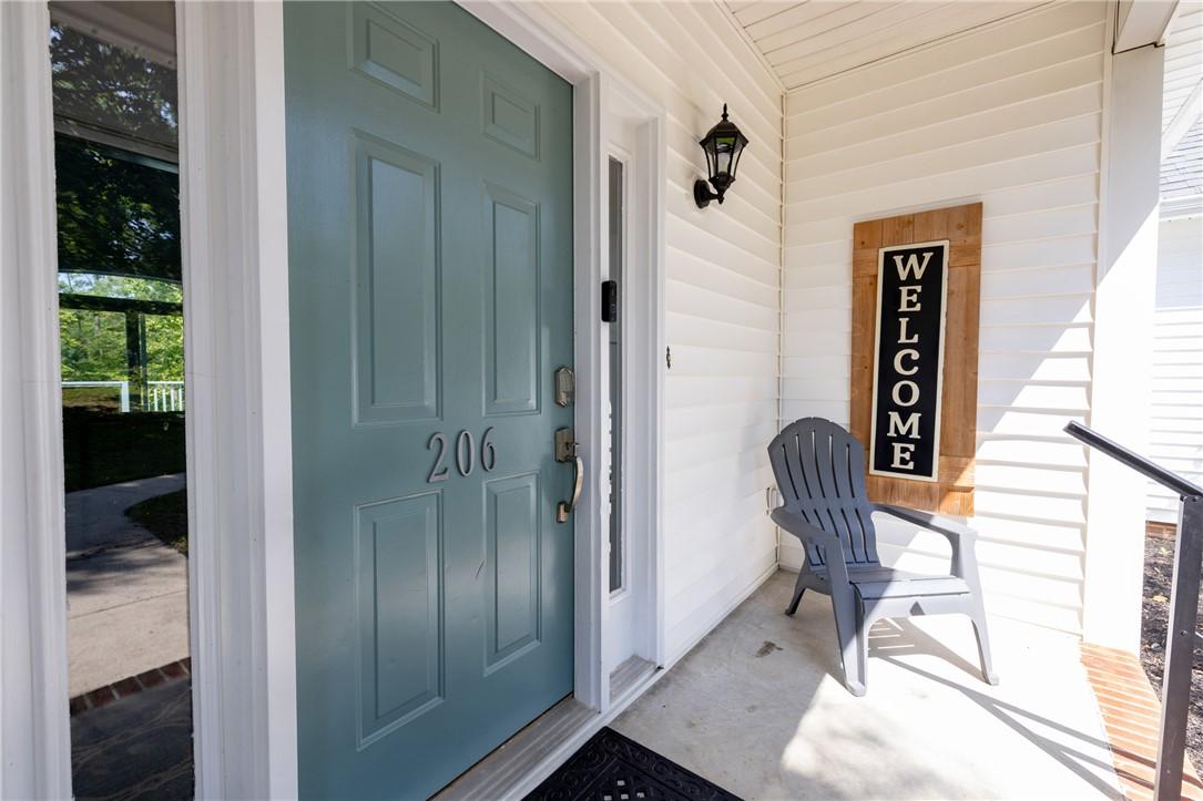 Image 4: A welcoming entry invites with a panel door and ch