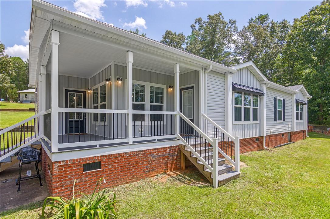 Image 3: A welcoming covered porch and charming exterior en
