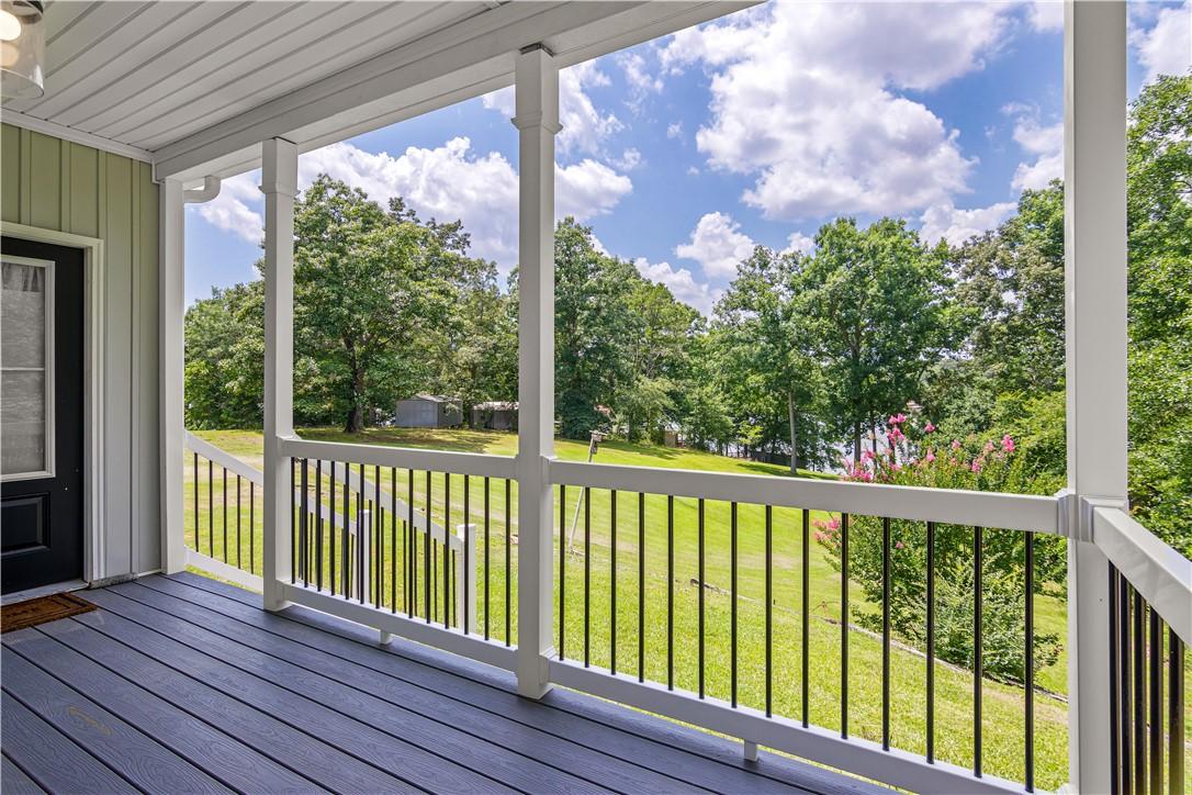 Image 4: A welcoming front porch with composite decking ove