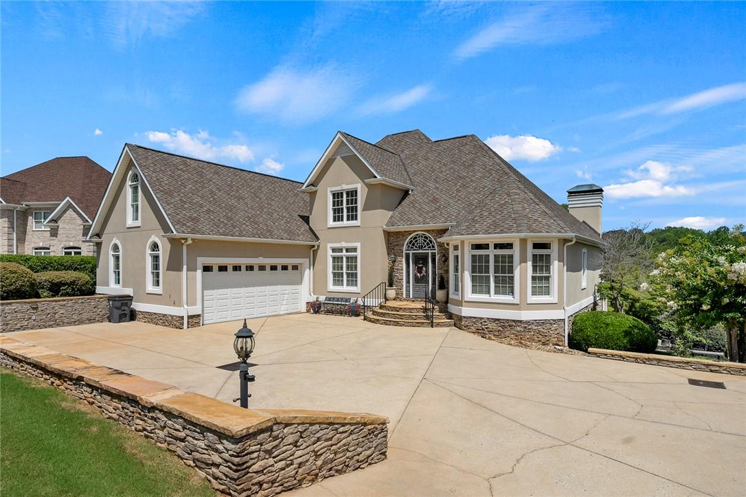 Image 2: A graceful home featuring a stacked stone foundati