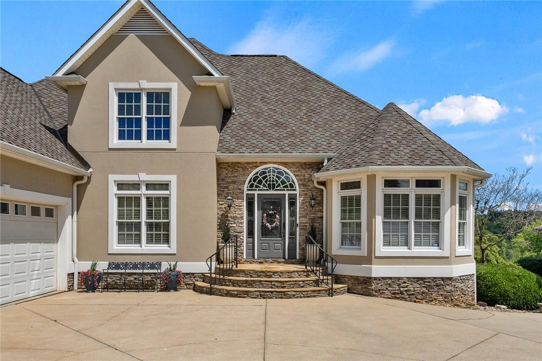 Image 3: A classic exterior with stone accents and a welcom