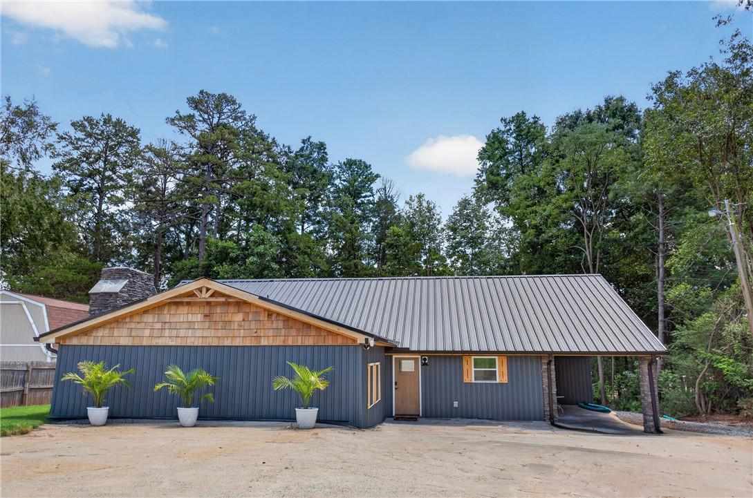 Image 2: A charming exterior with a blend of wood siding an
