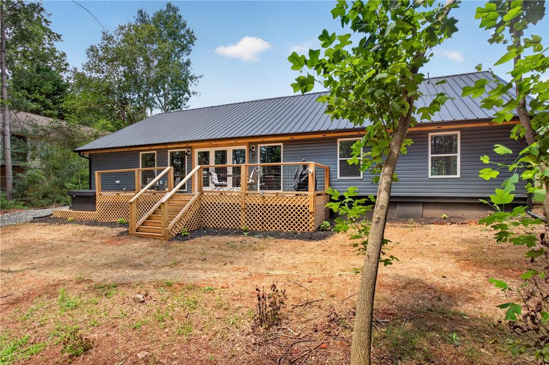 Image 4: A spacious wooden deck extends from the rear of th