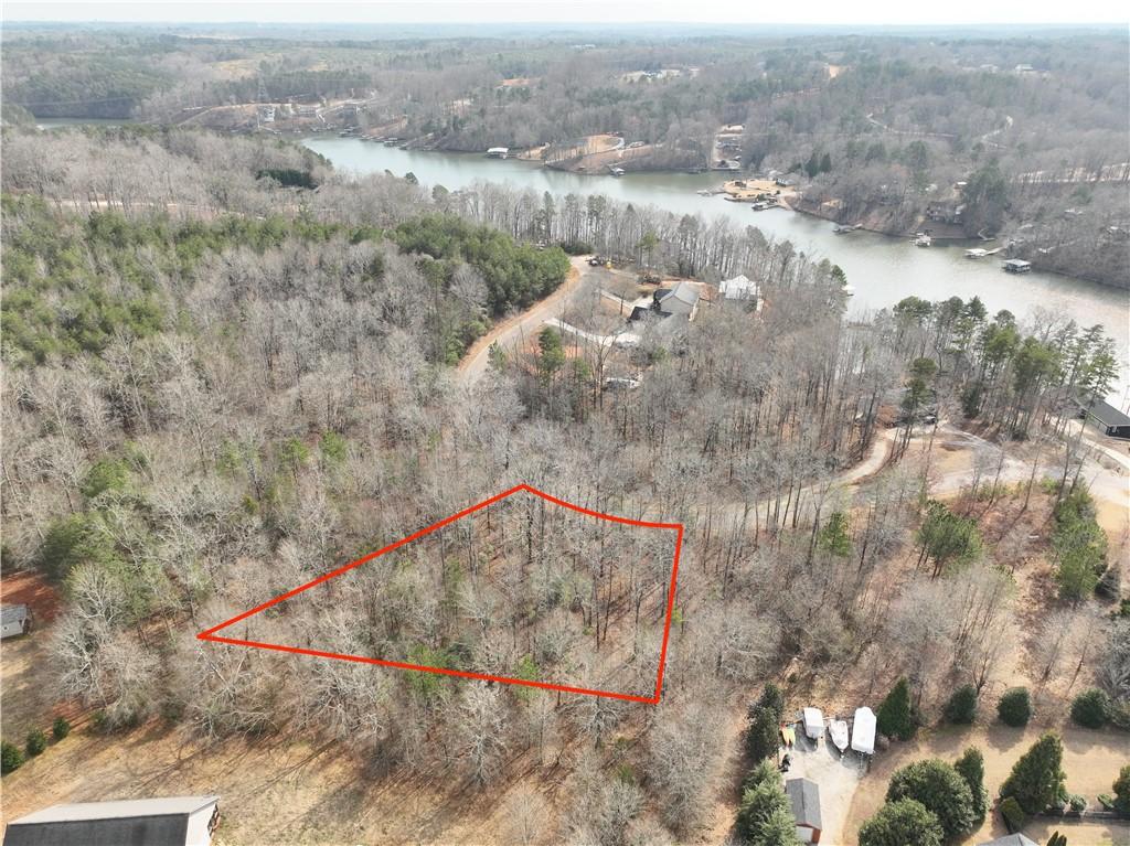 Image 1: This aerial view showcases a wooded lot offering t
