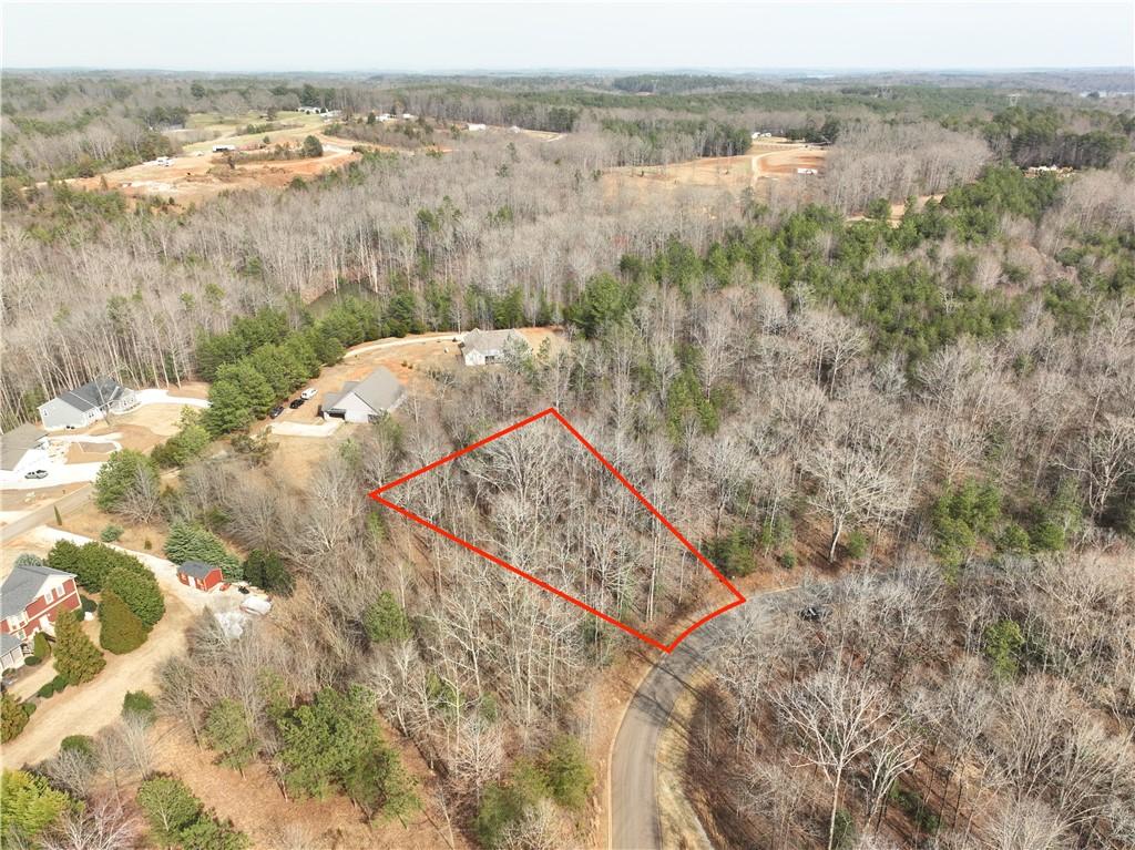 Image 4: This aerial view showcases a vacant lot, ready for
