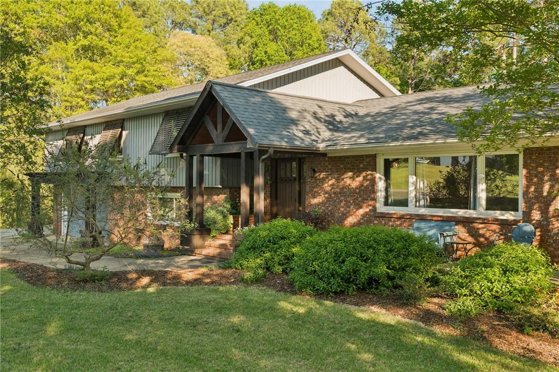 Image 1: This charming home features classic brick and sidi