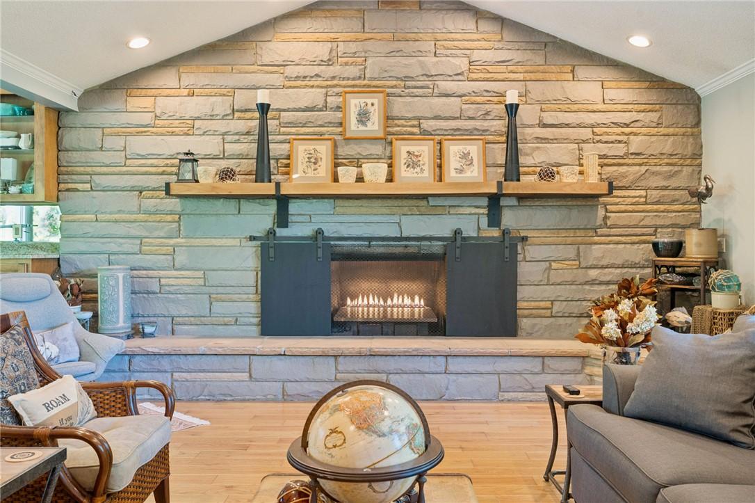 Image 2: This living room features a captivating stone fire