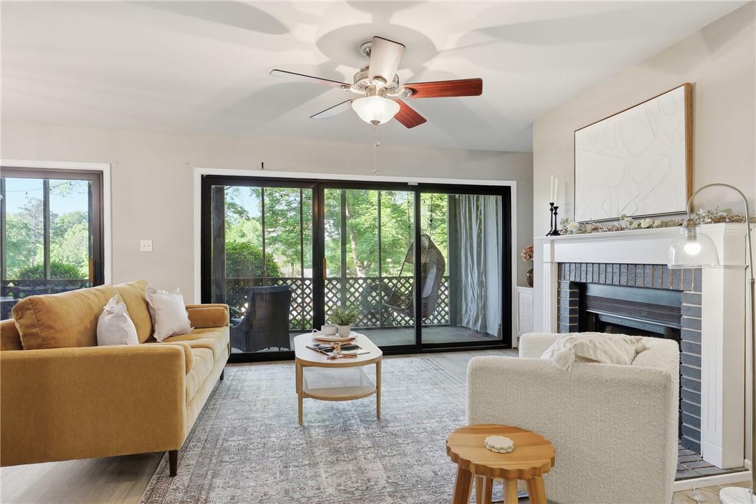 Image 4: This bright living area features a fireplace and d