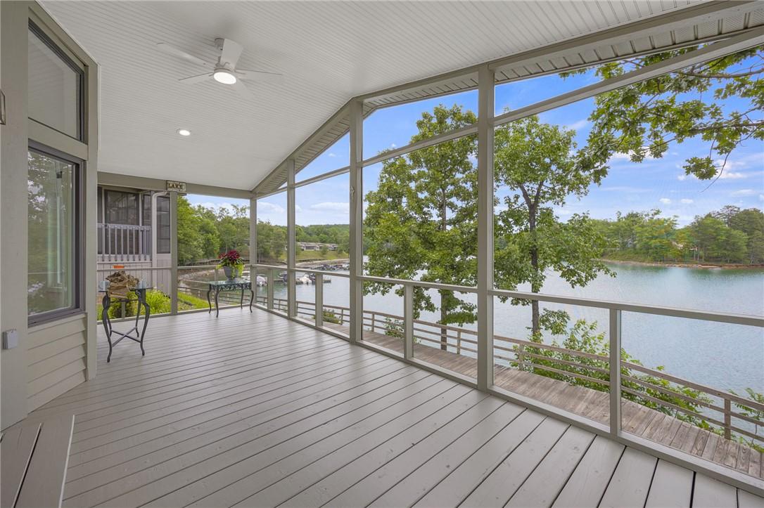 Image 2: A spacious screened porch overlooks a tranquil lak