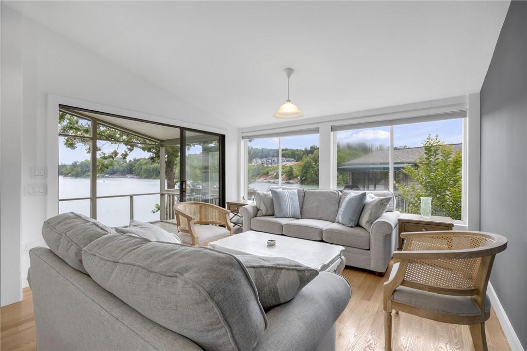 Image 4: A spacious living area with hardwood floors opens
