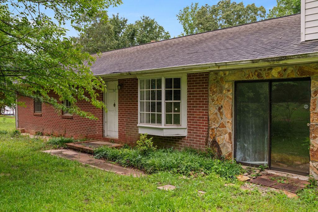 Image 2: Brick and stone accents adorn this charming home,