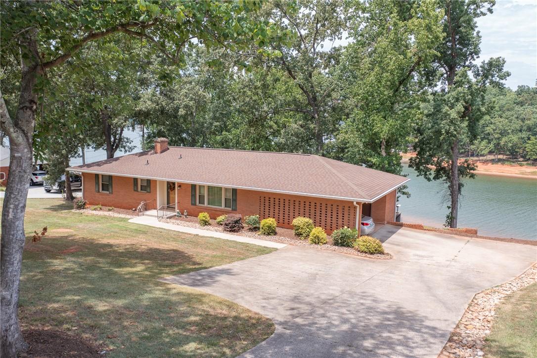Image 1: A charming brick residence awaits, boasting a sere