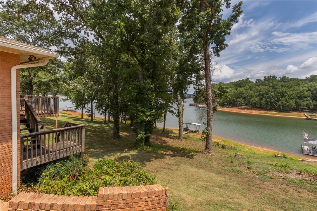 Image 3: A tranquil lakefront setting, featuring mature tre