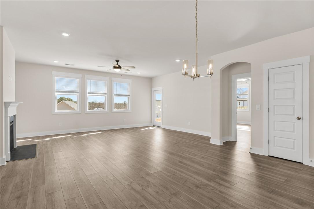 Image 3: This expansive living space features durable floor