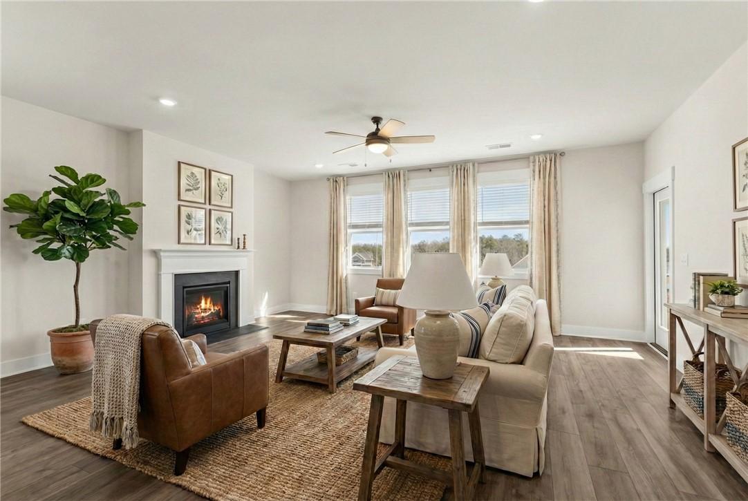 Image 4: This inviting living room offers abundant natural