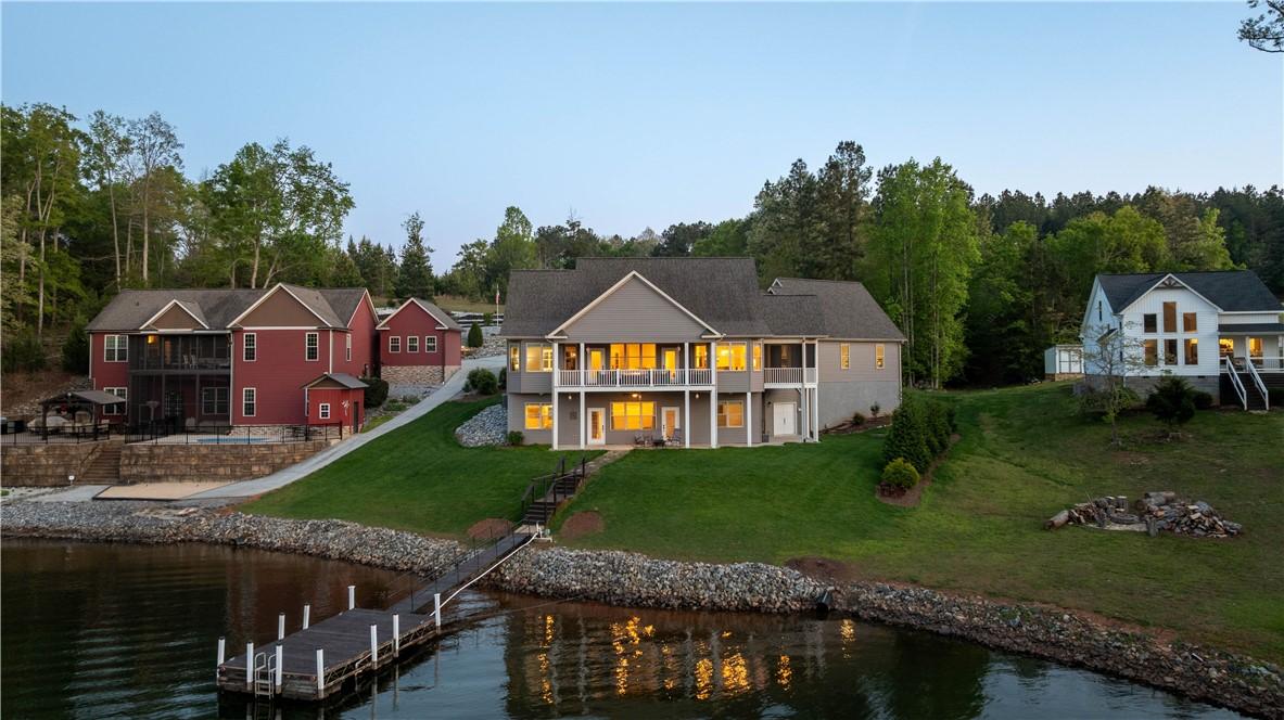 Image 2: A lakeside retreat features multiple structures, l