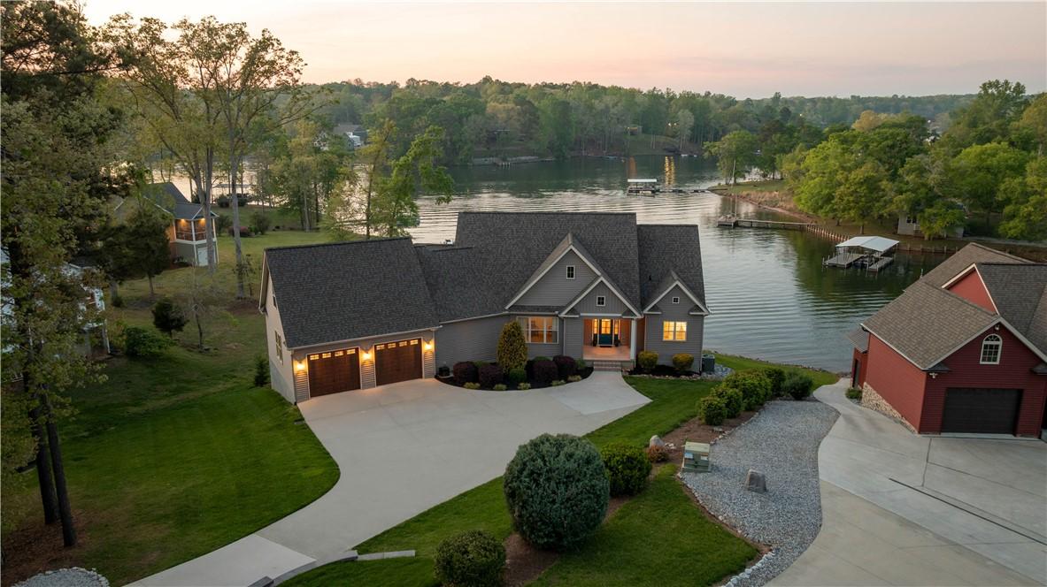 Image 3: Perched by the water, this home boasts ample parki