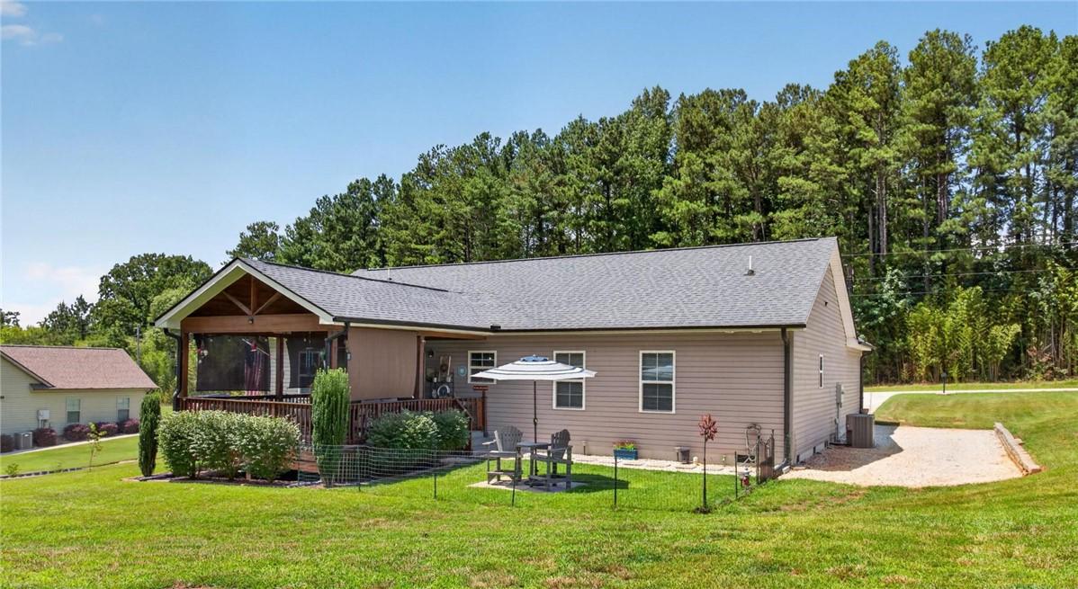 Image 3: An inviting screened porch and a paved patio area