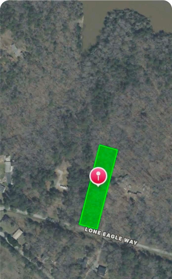 Image 1: This aerial view showcases a lot bordered by a tra