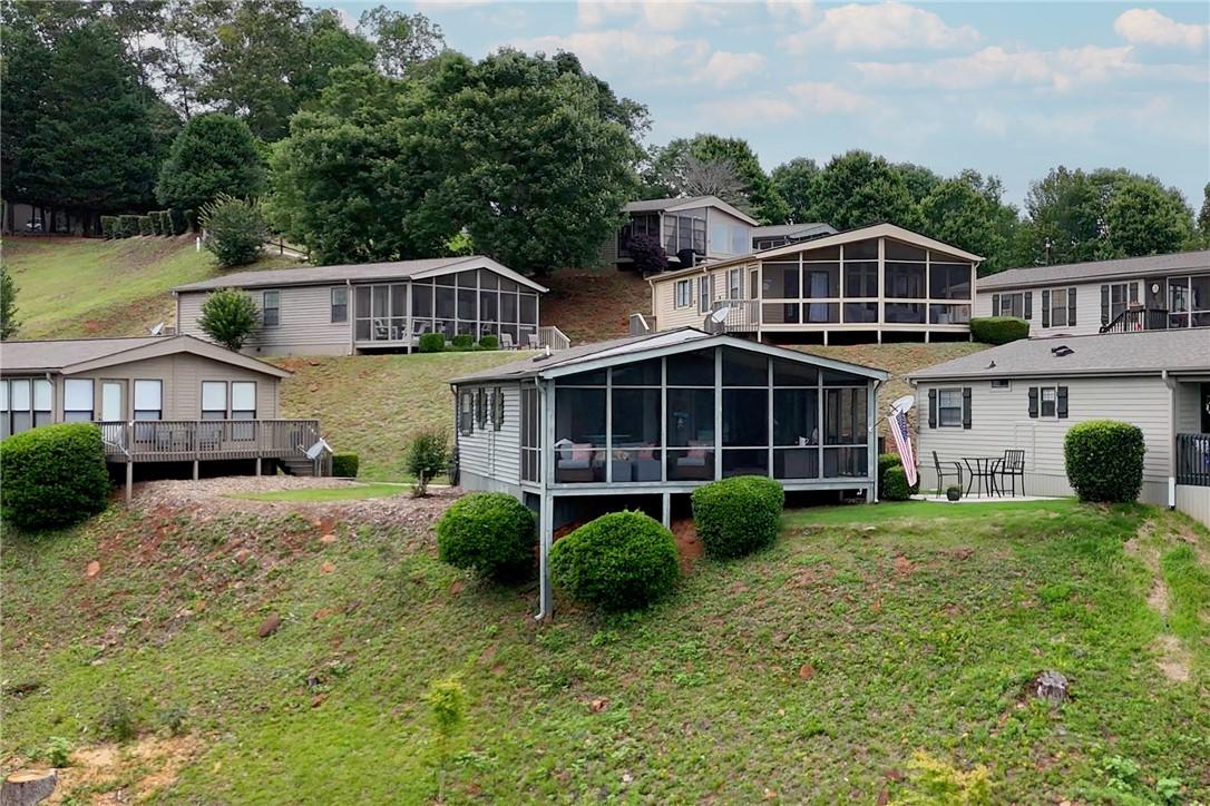 Image 2: Perched on a verdant hillside, these charming home