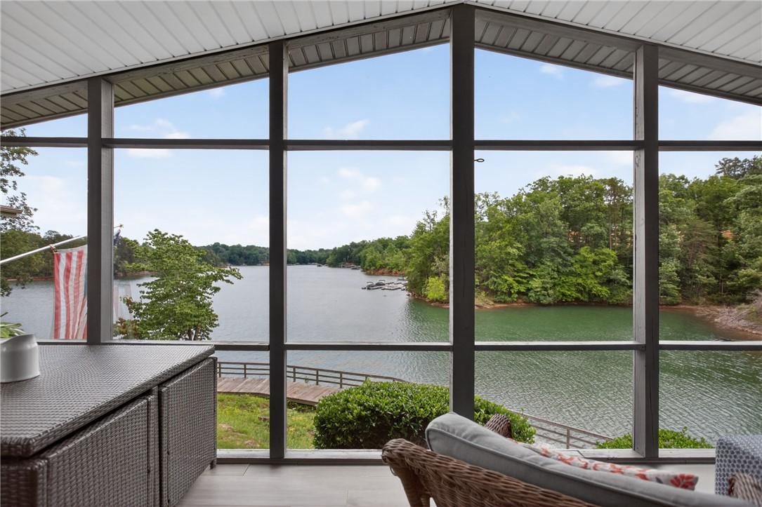 Image 3: Panoramic lake views from a charming screened porc