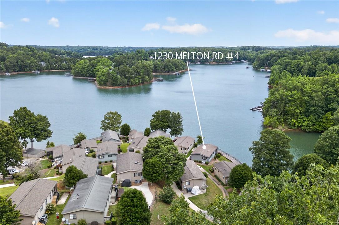 Image 4: An aerial panorama showcases a serene lakeside com