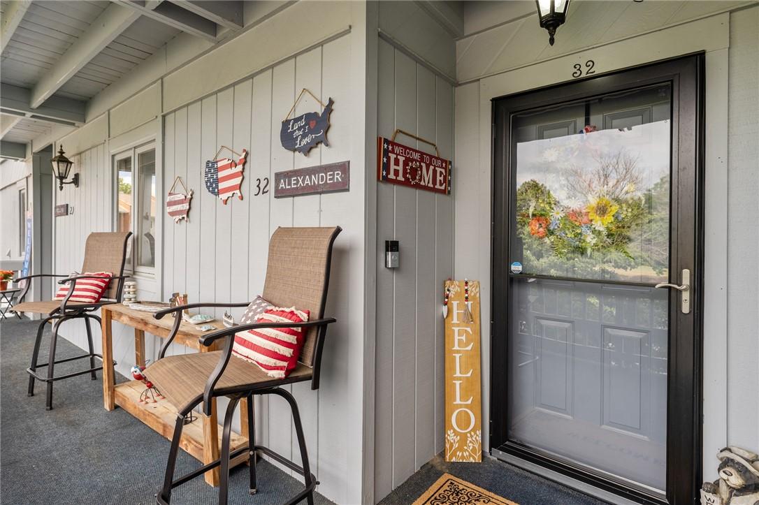 Image 2: A welcoming front entrance features a screened doo