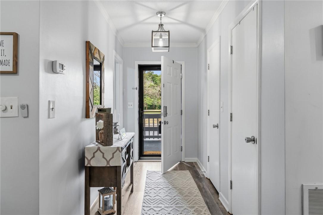 Image 4: A welcoming entry corridor features warm wood-look
