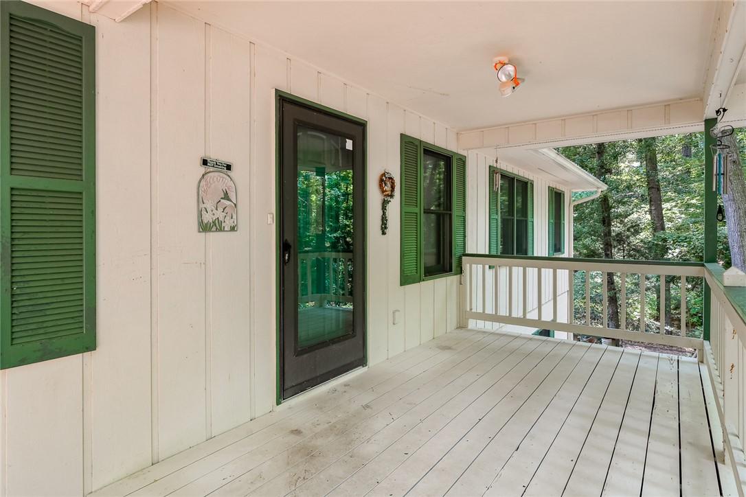Image 3: A welcoming front porch with white plank flooring
