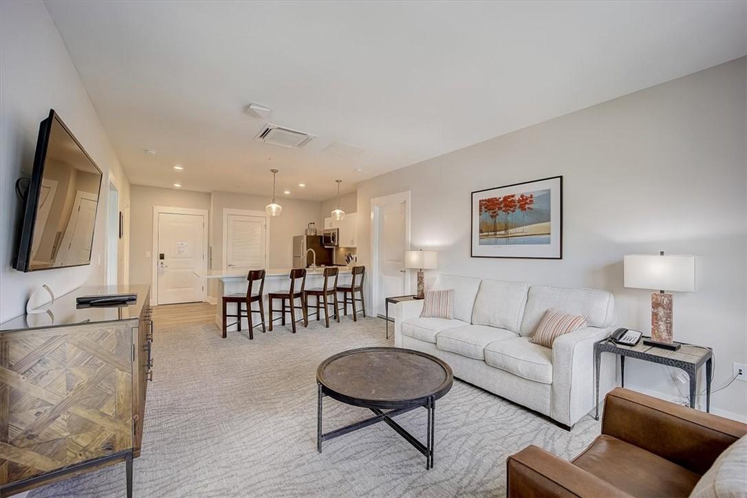 Image 3: An open concept living area transitions seamlessly