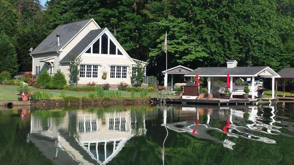 Image 1: This charming lakeside dwelling offers picturesque