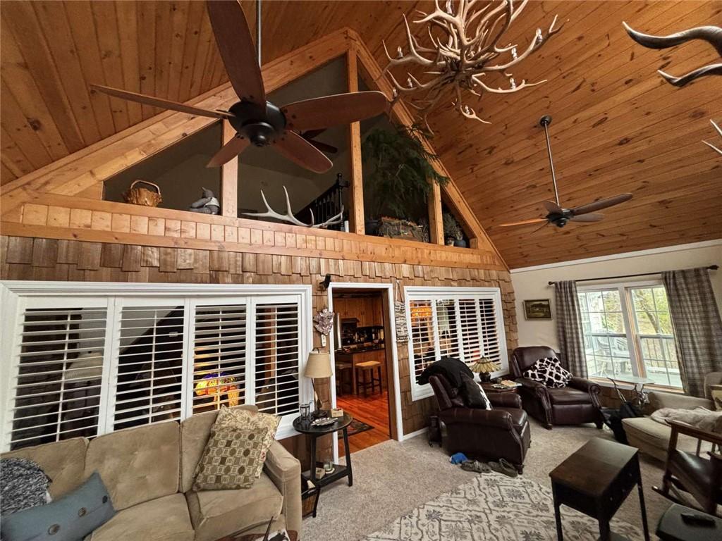 Image 2: This inviting living space features vaulted wood c