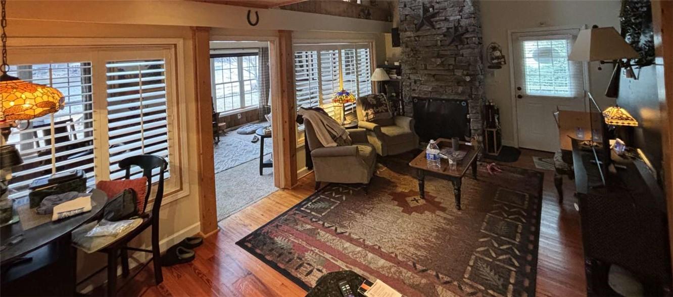 Image 3: This inviting living space features rich hardwood