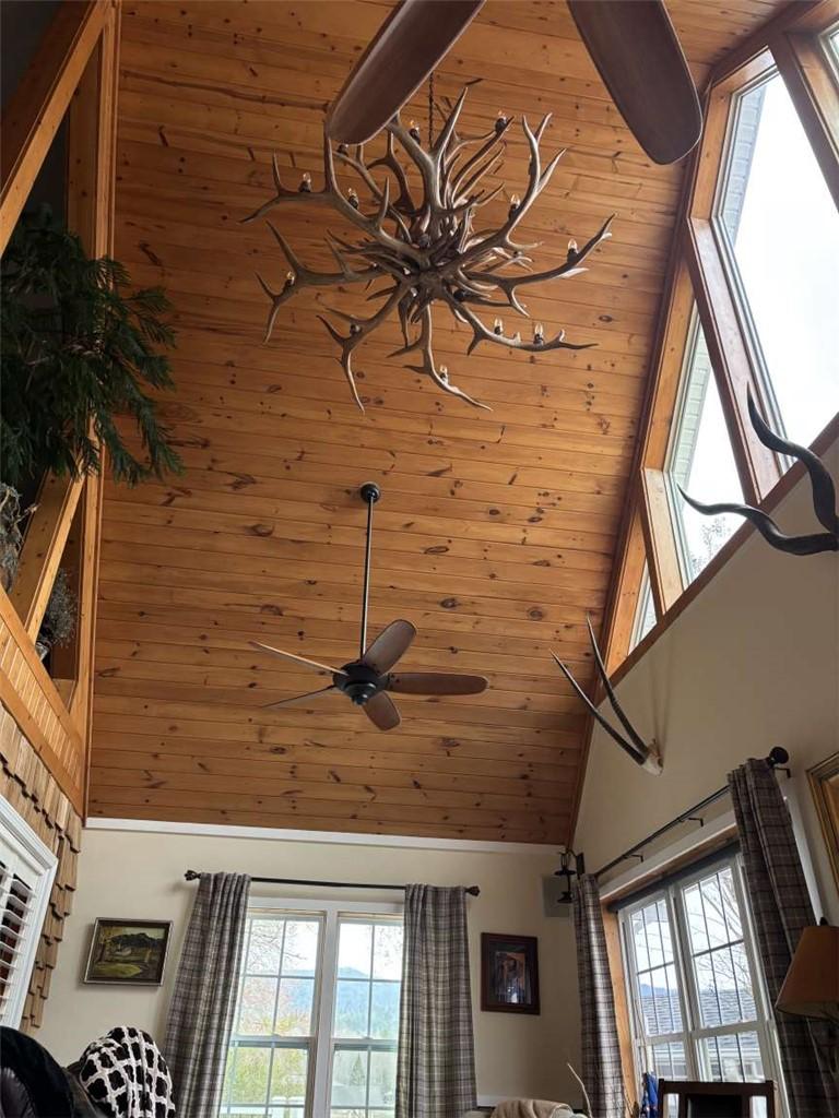 Image 4: This soaring great room features rich wood ceiling