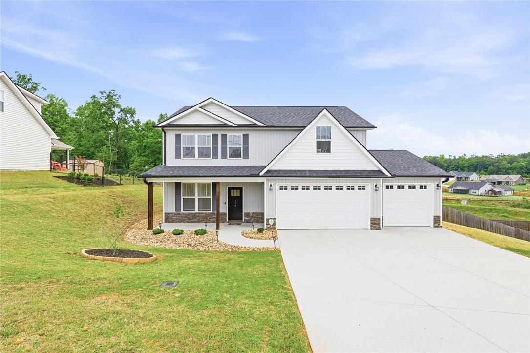 Image 1: This charming home offers a spacious driveway and