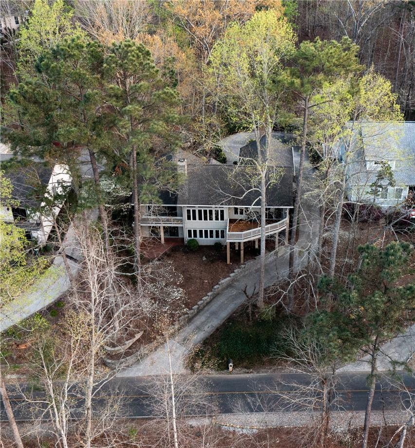 Image 1: Perched among mature trees, this expansive home fe