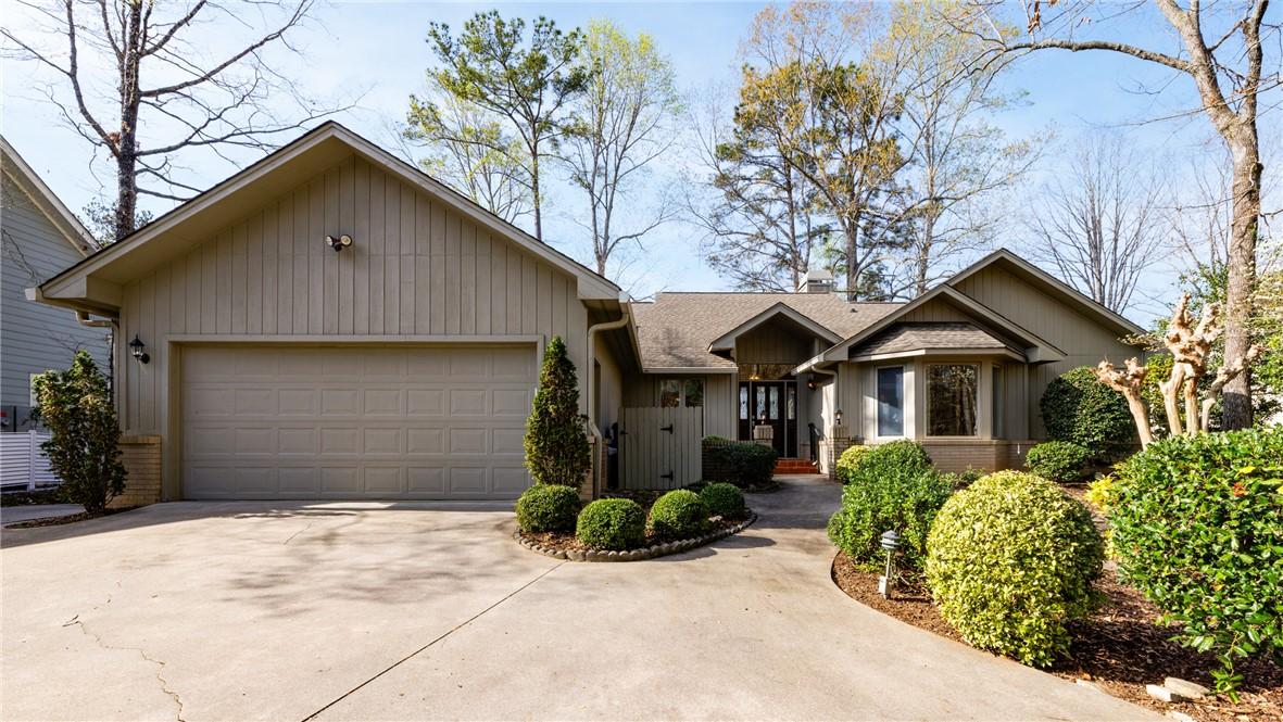 Image 2: A welcoming driveway leads to this charming home,