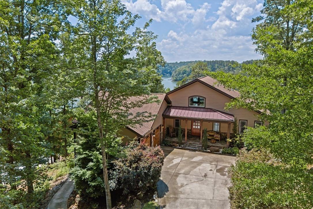 Image 2: A tranquil lakeside retreat with a welcoming front