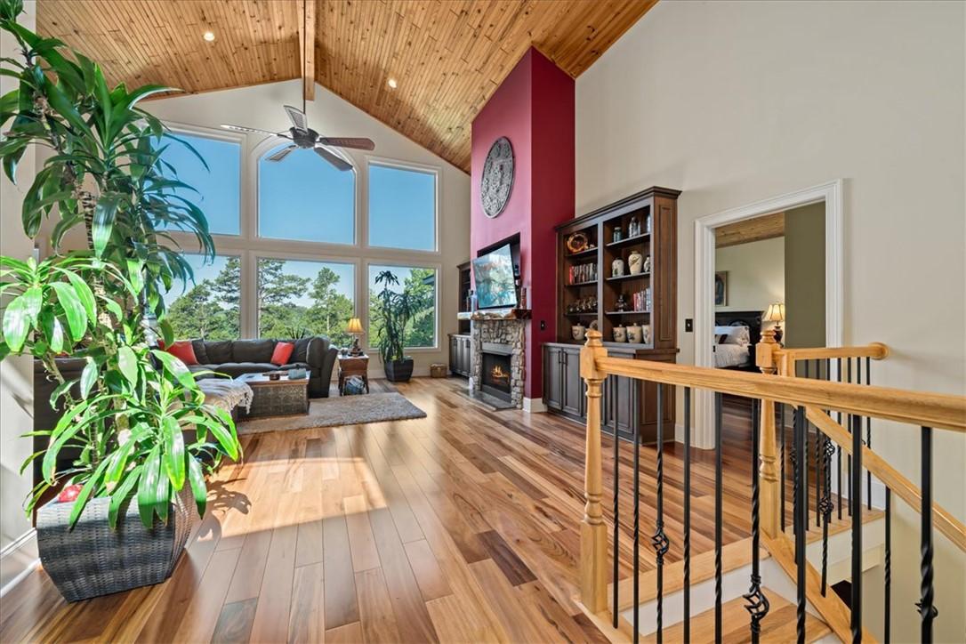 Image 3: A spacious great room boasts soaring vaulted ceili