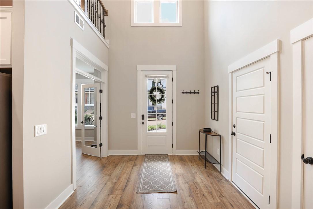 Image 2: A welcoming entryway with soaring ceilings and ric