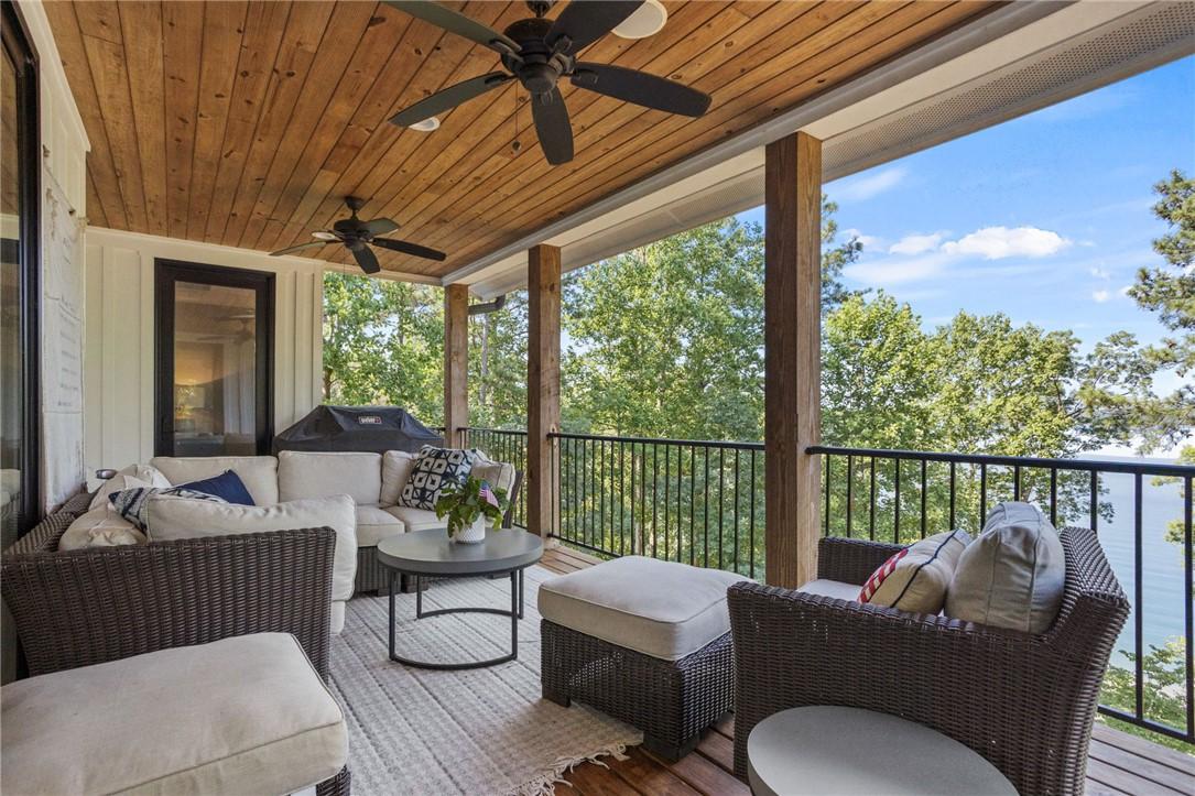 Image 3: An inviting covered deck offers serene lake views